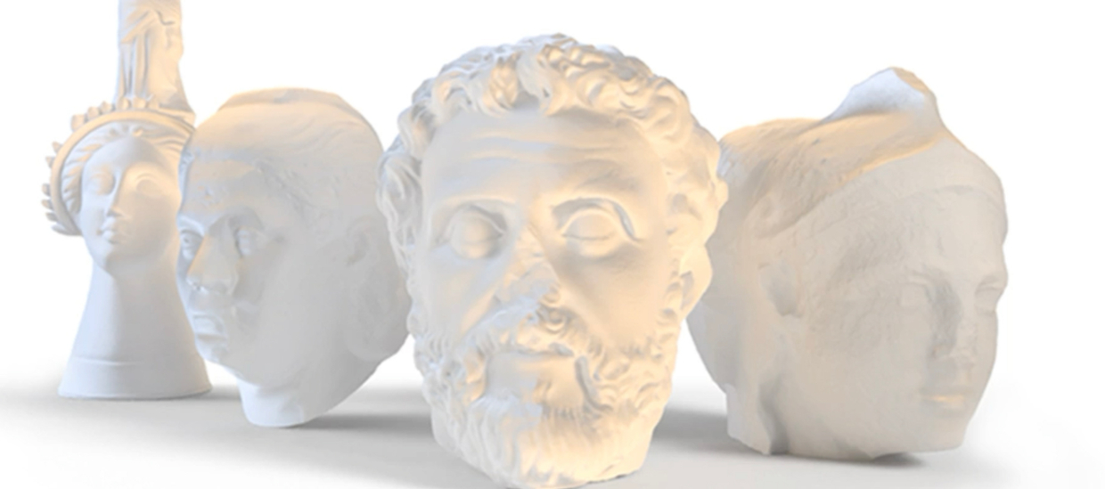 image of white 3d prints of ancient Greek artifacts. One a vessel for holding one and 3 heads from marble statues